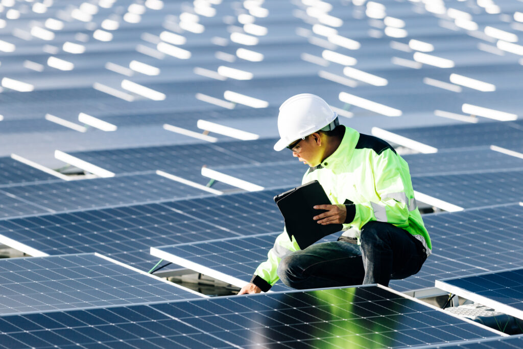 Asian engineer with digital tablet his hand who plans expand plant with solar panels