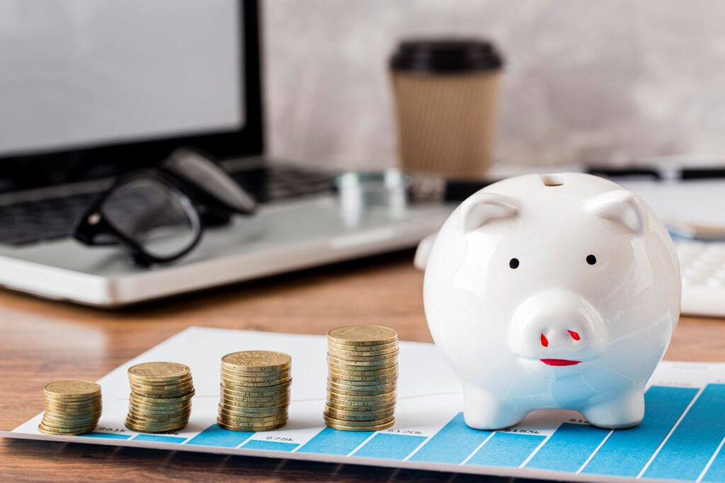 Laptop with piggy bank growth chart