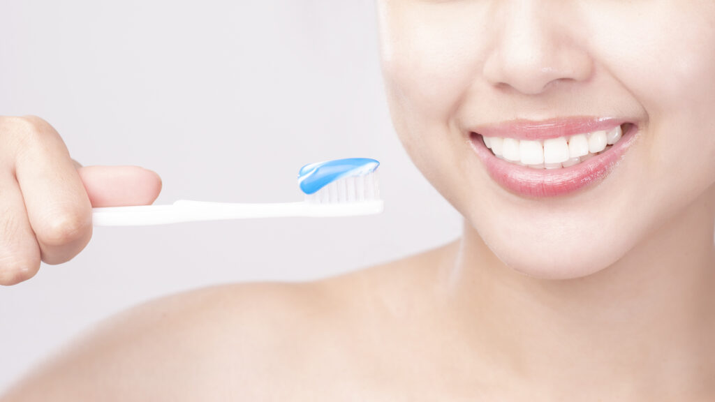 Close up of white healthy teeth of beautiful smile young woman