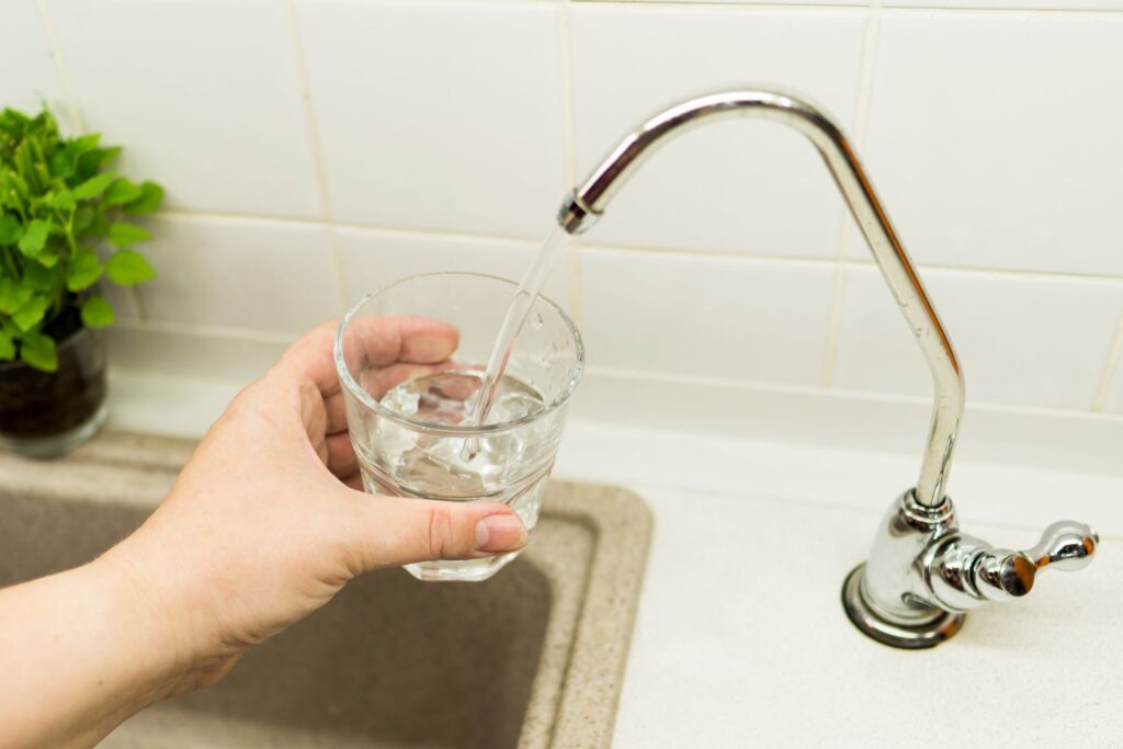 Close up woman hand holding glass water
