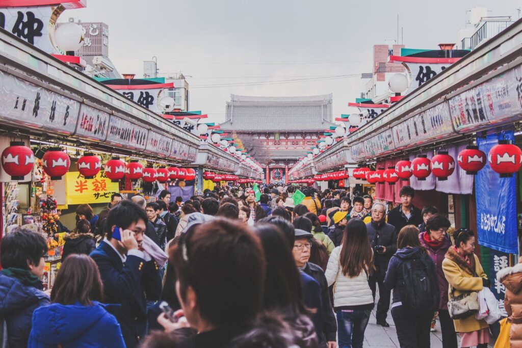 People walking street amidst stalls market