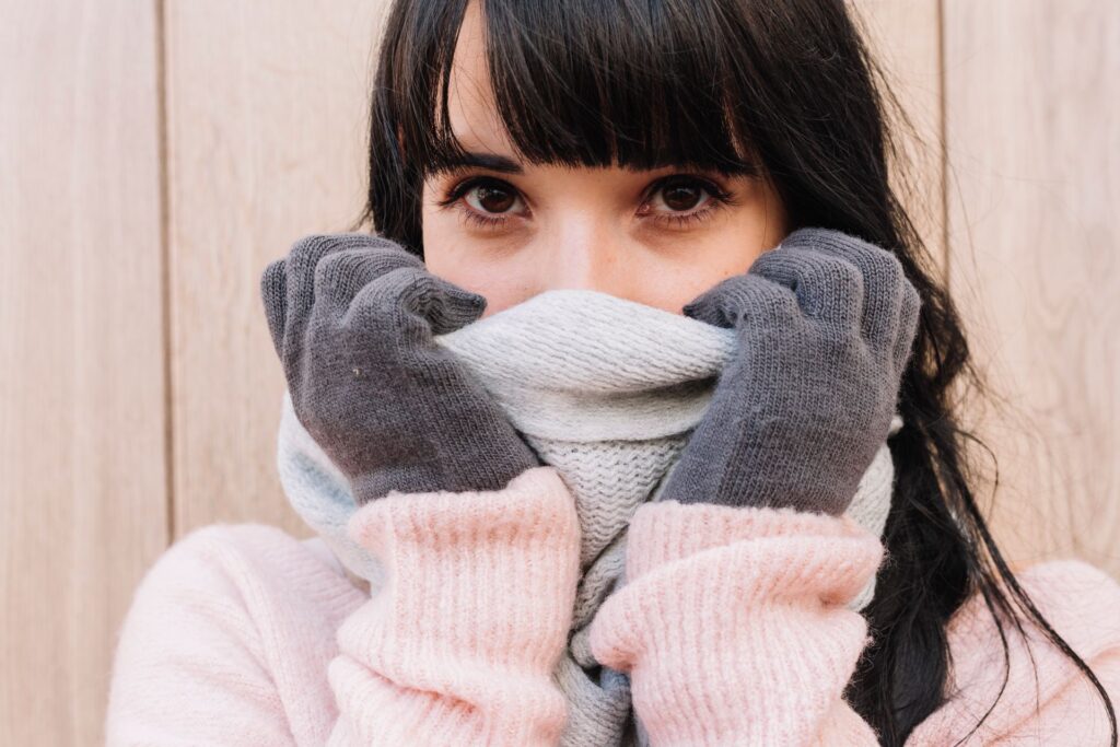 Woman covering nose with scarf